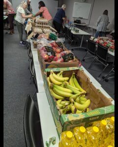 Mannahelp food distribution event - Volunteers help sort food items.