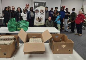 Volunteers pose for a picture at the Mannahelp food distribution event for the needy